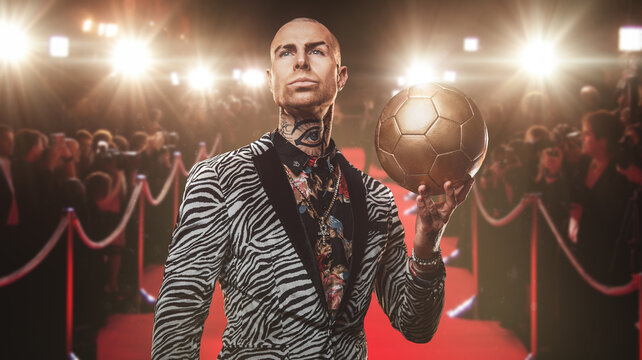 Art of handsome football player dressed in trendy suit holding soccer ball.