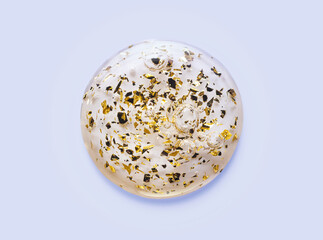 Luxury gold 24k cosmetic serum or toner smudge on gray background