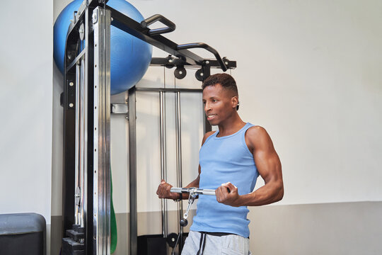 Athletic man exercising in the gym. Sport and healthy lifestyle concept.