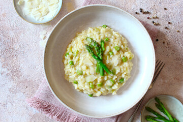 Italian risotto with asparagus and parmesan cheese on table. Top view.