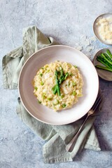 Italian risotto with asparagus and parmesan cheese on table. Top view.