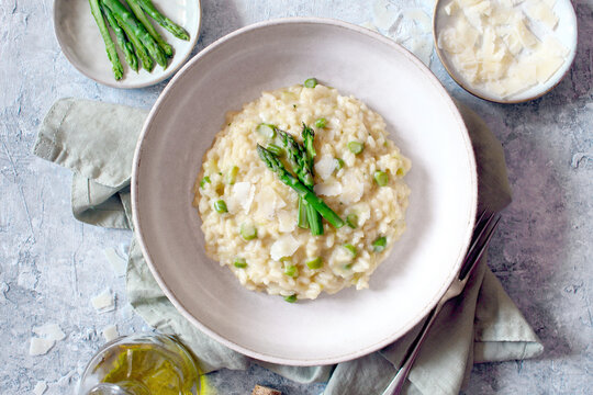 Italian risotto with asparagus and parmesan cheese on table. Top view.