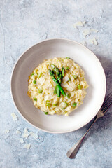 Italian risotto with asparagus and parmesan cheese on table. Top view.