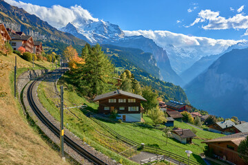 Obraz na płótnie Canvas Autumn view from Swiss alpine village of Wengen to the Lauterbrunnen valley and the mountain railway.