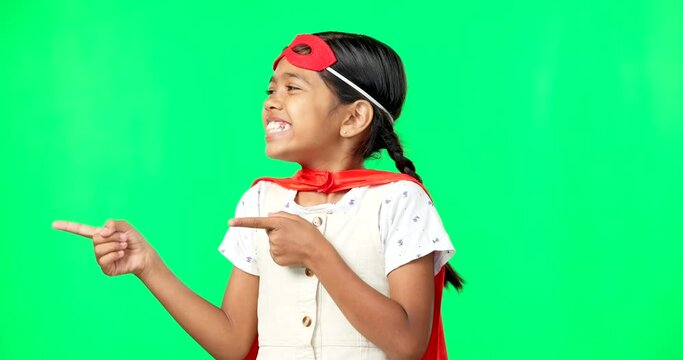 Face, green screen and girl in costume, pointing and dancing against studio background. Portrait, female child and young person with hero outfit, celebration and dance with smile, superhero or joyful