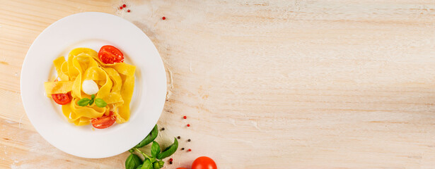 Obraz na płótnie Canvas Yellow italian pasta pappardelle, fettuccine or tagliatelle