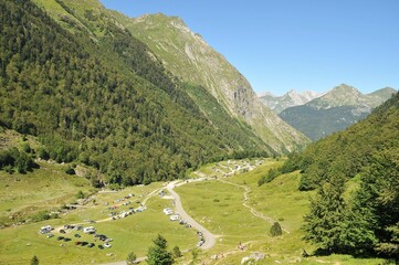 Beautiful view of the mountain range and green valley with cars.