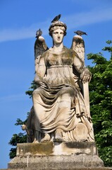 Pigeons on angel sculpture in Jardin des Tuileries, Paris, France