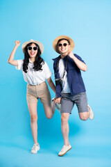 Fototapeta premium Asian couple traveling image isolated on blue background