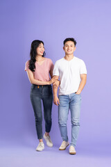 Fototapeta premium full body image of asian couple posing on purple background