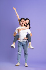 full body image of asian couple posing on purple background