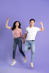 Fototapeta premium full body image of asian couple posing on purple background