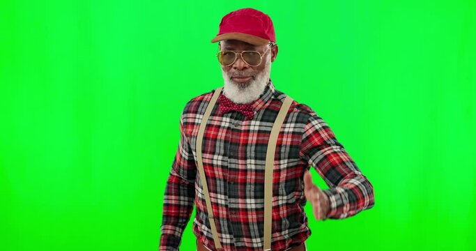 Dance, music and a mature black man on a green screen background in studio having fun moving with rhythm. Party, fashion and funky with a happy senior man dancing on chromakey mockup for freedom