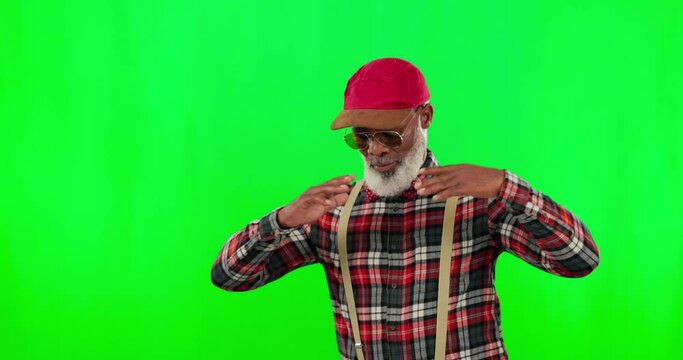 Dance, music and an elderly black man on a green screen background in studio having fun moving with rhythm. Party, fashion and funky with a happy senior man dancing on chromakey mockup for freedom