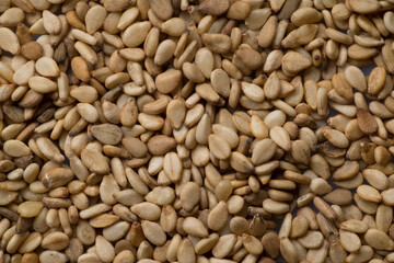 Pile of white sesame seeds as a background, top view