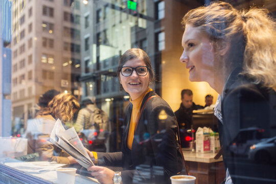 Two businesswomen talking in cafe