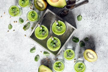 Avocado smoothie with fruits on the table. Top view. Detox drink.