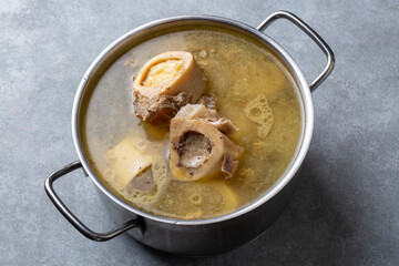 Boiled bone and broth. Homemade beef bone broth is cooked in a pot on. Bones contain collagen, which provides the body with amino acids, which are the building blocks of proteins.