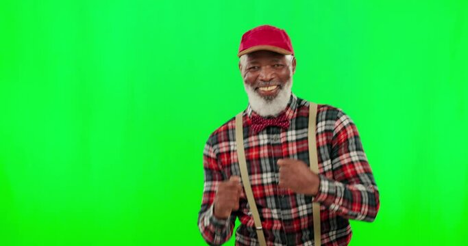 Dance, music and a funny senior black man on a green screen background in studio having fun moving to rhythm. Party, fashion and funky with a happy elderly man dancing on chromakey mockup for freedom