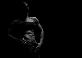 Obraz na płótnie Canvas Black and white image of a sports girl on a black background. Fitness concept.