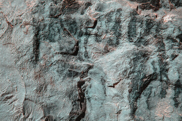 Stone texture of an old rough building wall with cracks, reliefs, plots. Random pattern