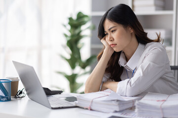 Asian women are stressed or has sore throat at office while working on laptop, Tired asian businesswoman with headache at office, feeling sick at work, copy space