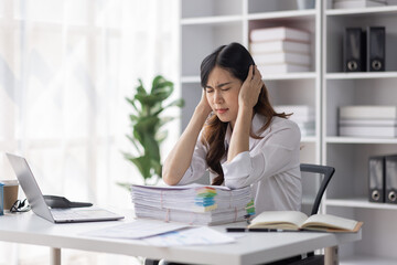 Asian women are stressed or has sore throat at office while working on laptop, Tired asian businesswoman with headache at office, feeling sick at work, copy space