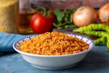Traditional turkish bulgur pilaf with tomato sause in plate (Turkish name; meyhane pilavi)