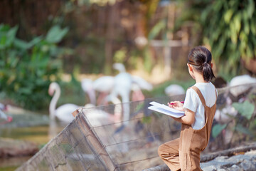 The girl is having a fun field trip to the zoo and took notes.