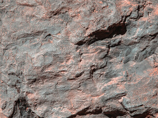 Stone texture of an old rough building wall with cracks, reliefs, plots. Random pattern