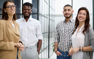 Fototapeta premium Successful team of young perspective businesspeople in office