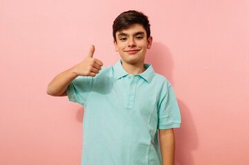 Young guy doing finger up positive gesture in studio.