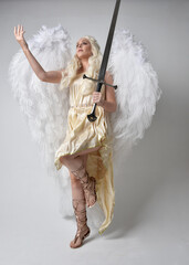 Full length portrait of beautiful blonde woman wearing a fantasy goddess toga costume with...