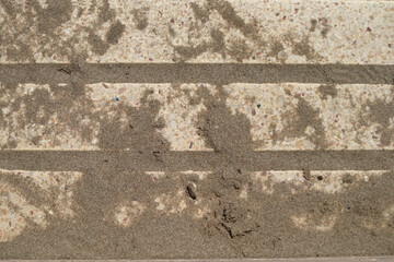 Fototapeta premium Some bricks filled with sand on a promenade next to the tourist beach