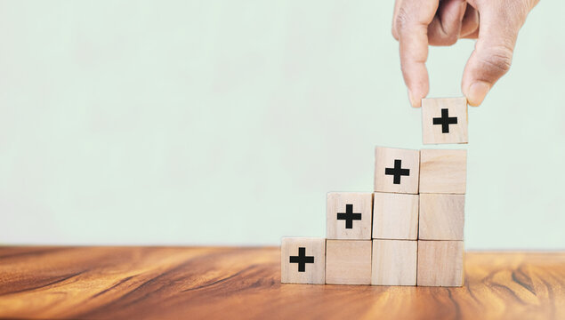  Positive Things; Added Value, Benefits, Additional, Personal Development, Growth Mindset, Positive Thinking, Opportunities, Emerging Market. Putting The Cubes With Plus Sign To Offer Positive Things