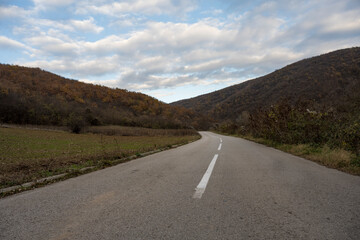 Empty asphalt road in rural landscape with dramatic clouds. Open Road. Summer country road. Asphalt...