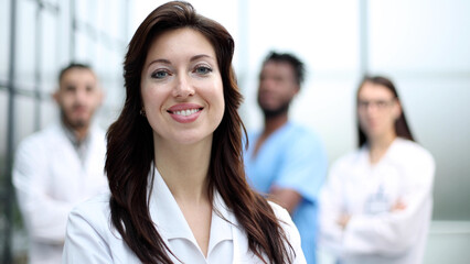 Fototapeta premium Portrait of a beautiful female doctor in a hospital, medical care.
