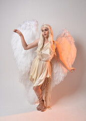 Full length portrait of beautiful blonde woman wearing a fantasy goddess toga costume with...