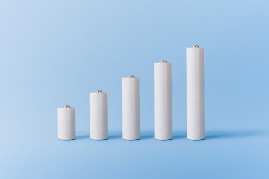 Various white batteries on blue surface