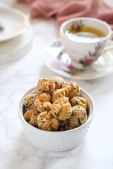 onde onde ketawa, Indonesian snack made from deep fried wheat flour mixing sticky rice flour and sesame seeds as topping. mini bite size