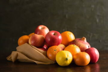 Fruit in a reusable bag. Earth day and zero waste concept. Apples, lemon, oranges and pomegranate...