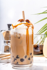 Tapioca boba balls coffee frappe, asian trendy cold coffee drink with tapioca balls and whipped...