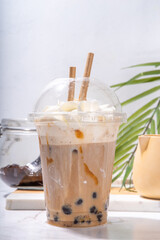 Tapioca boba balls coffee frappe, asian trendy cold coffee drink with tapioca balls and whipped...