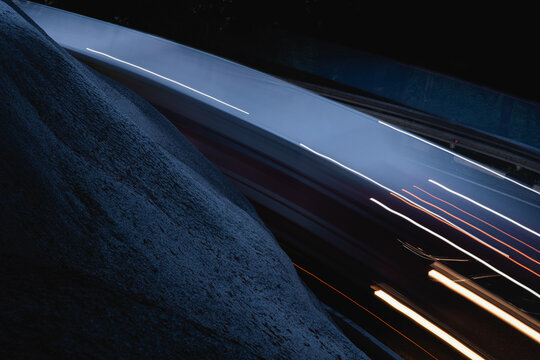 Asphalt road with moving cars in dark