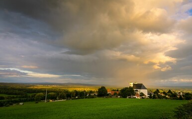 Obraz premium Sanctuary Church under dramatic sky with glowing clouds