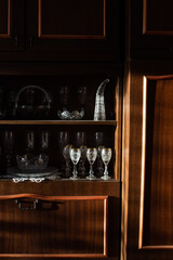collection of crystal glasses in a vintage cabinet
