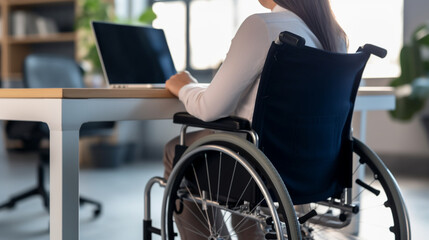 Obraz premium Fictional Person, Equality at Work: A Person in a Wheelchair Working with a Laptop, generated by IA 