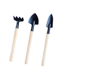 Set of garden tools, Shovels and Rake with wooden handles isolated on white background, Miniature gardening tools kit