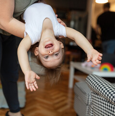 Cute child giggles upside down