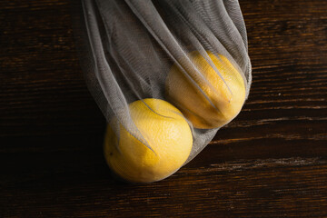 Earth day, recycling and zero waste concept. Lemons in a reusable mesh for fruits and vegetables on...